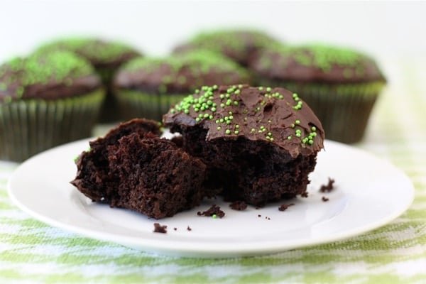chocolate-zucchini-cupcakes chocolate zucchini cupcake broken in half on plate.