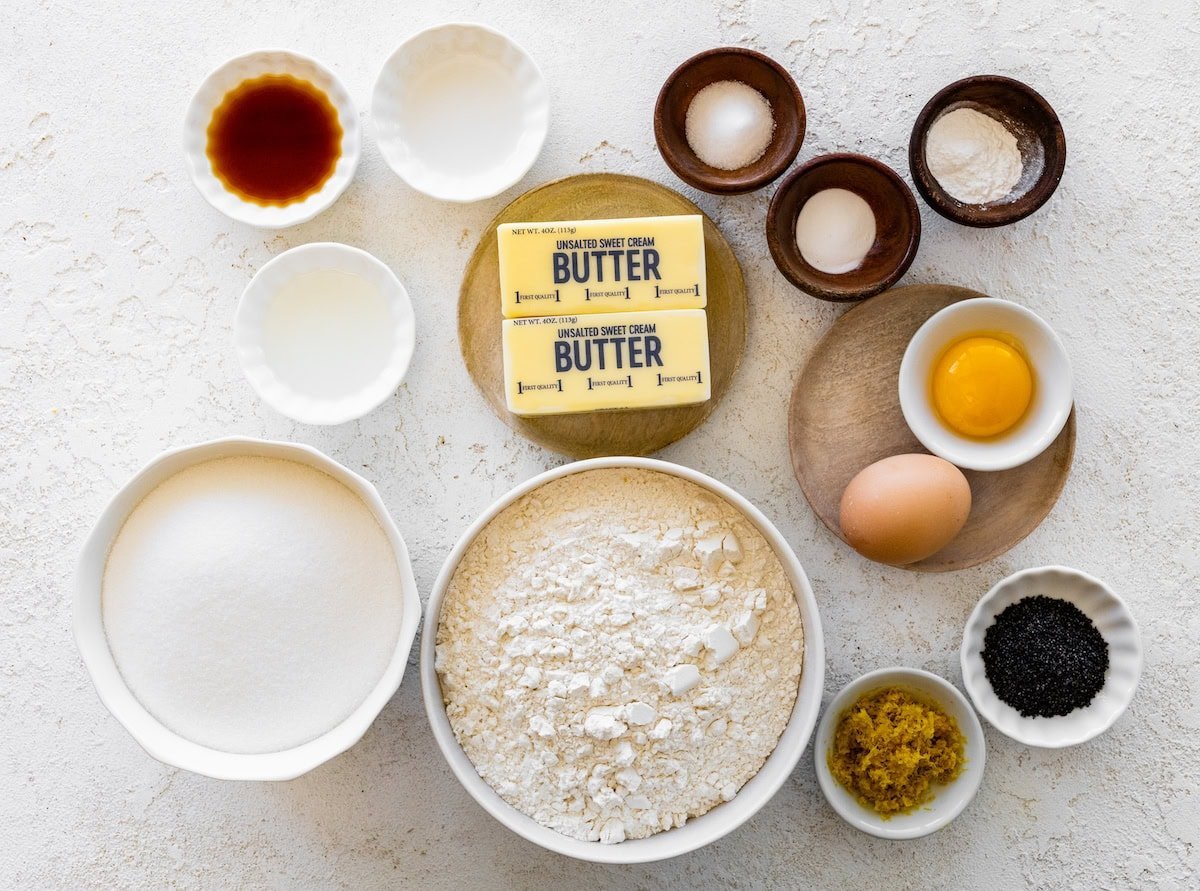 Ingredients in bowls to make lemon poppy seed cookies.