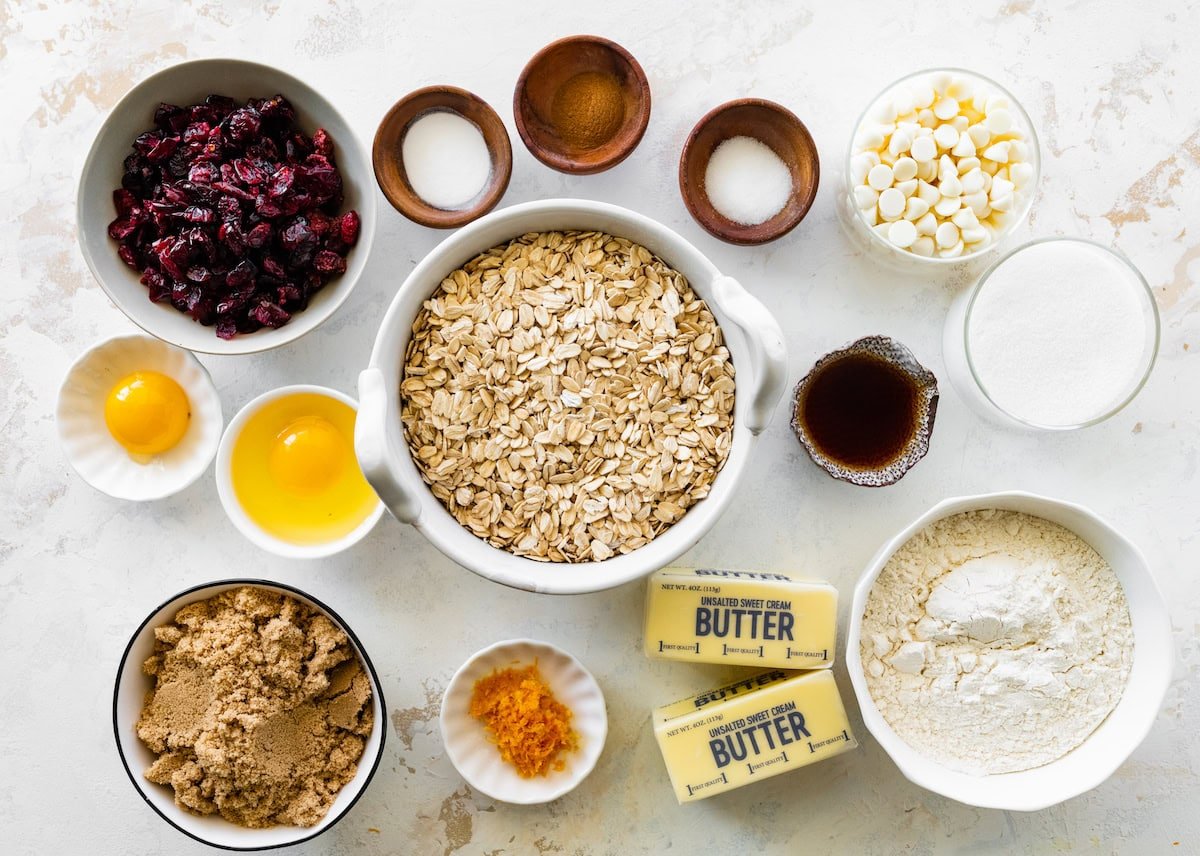ingredients in bowls to make cranberry orange white chocolate chip oatmeal cookies.
