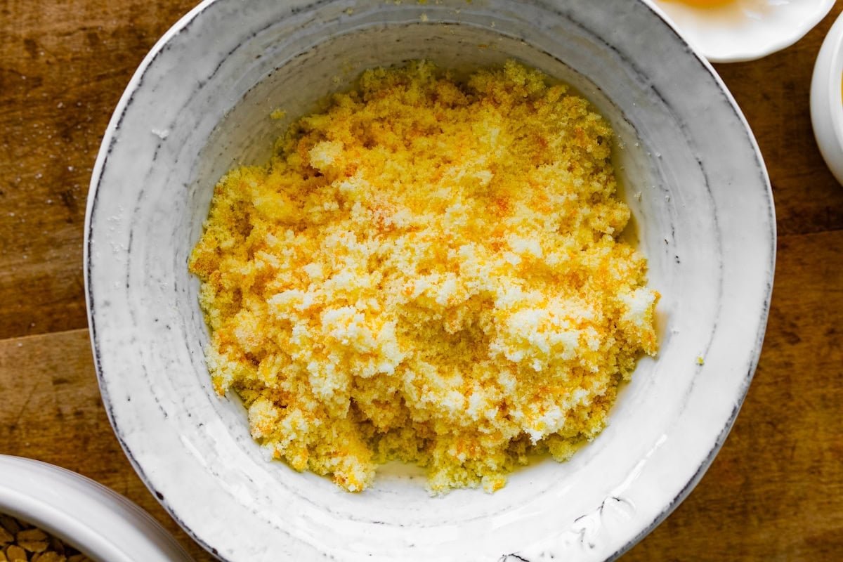 orange zest and granulated sugar combined in bowl.