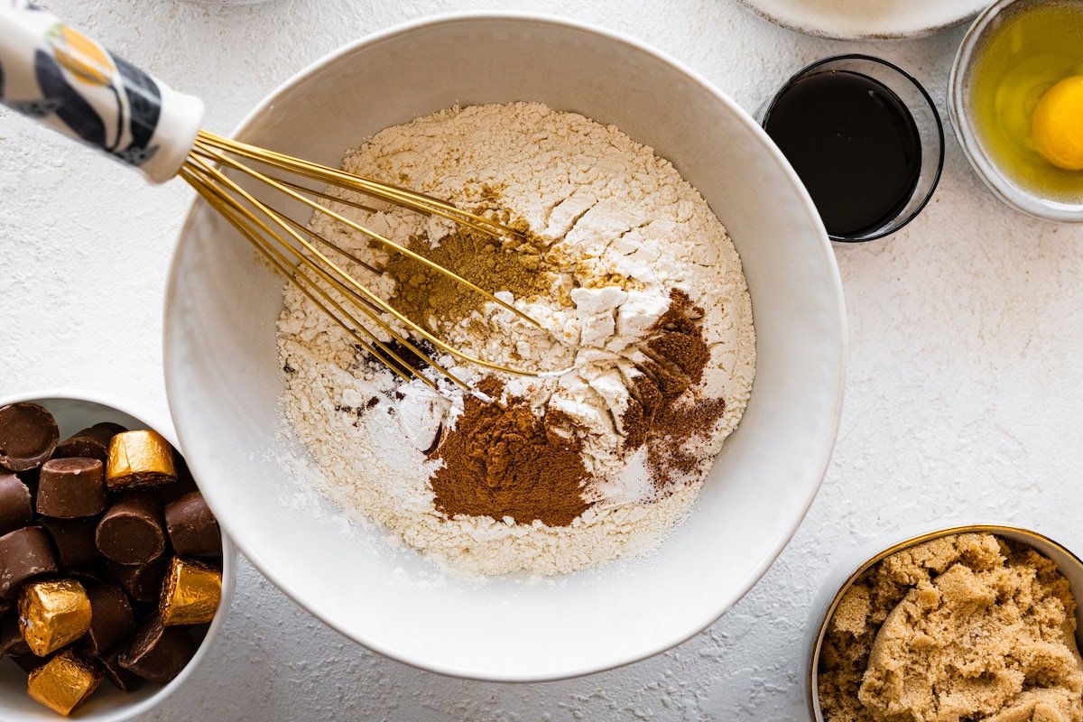 flour and spices being whisked together in mixing bowl.