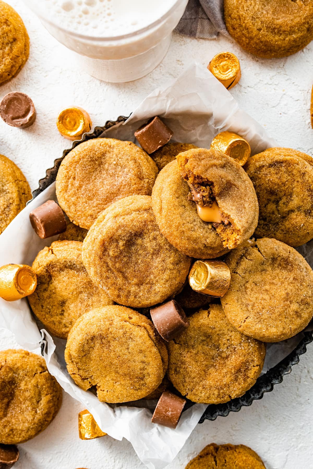ginger molasses rolo cookies in tray with rolo candies.