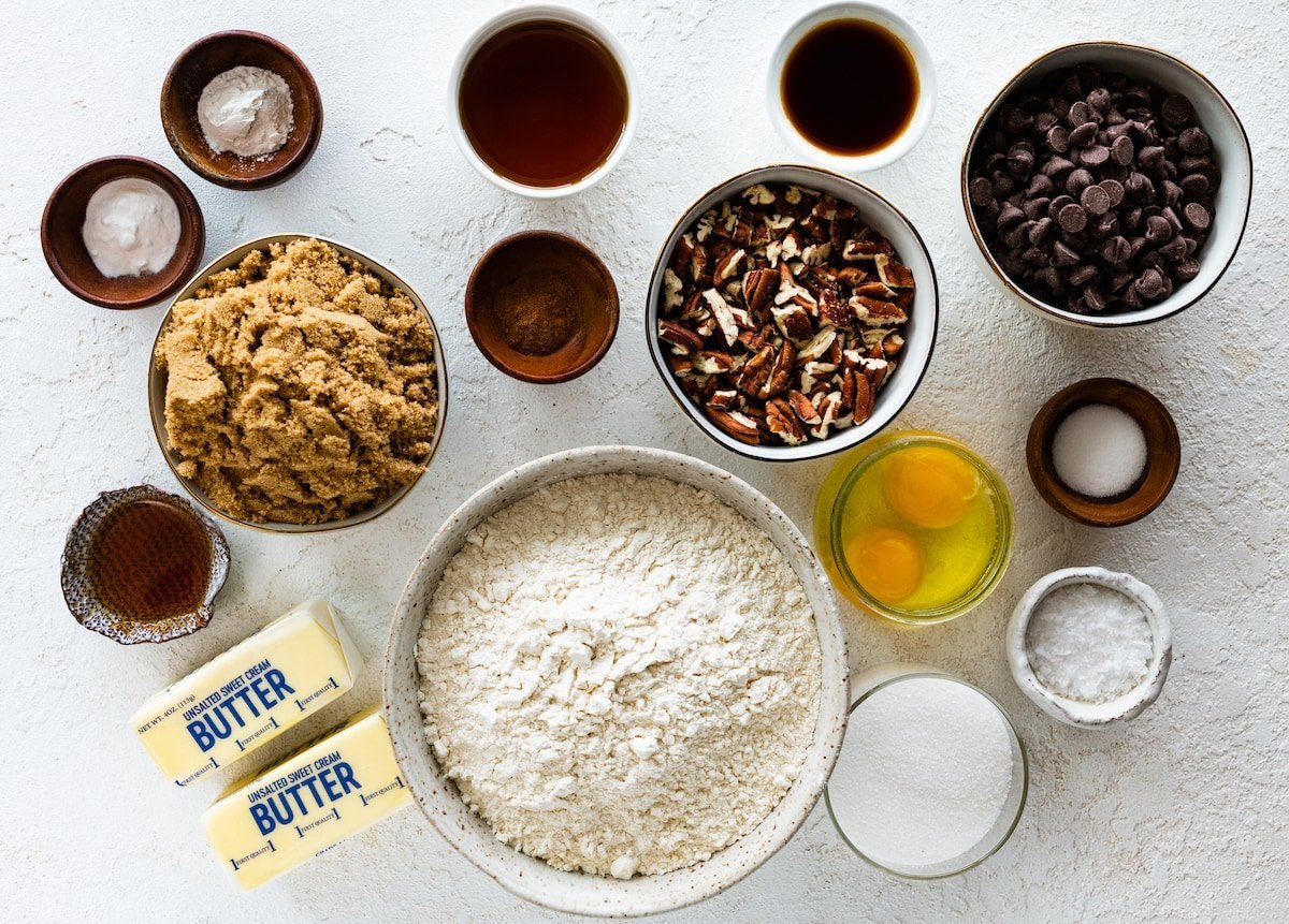 ingredients in bowls to make maple pecan chocolate chip cookies.