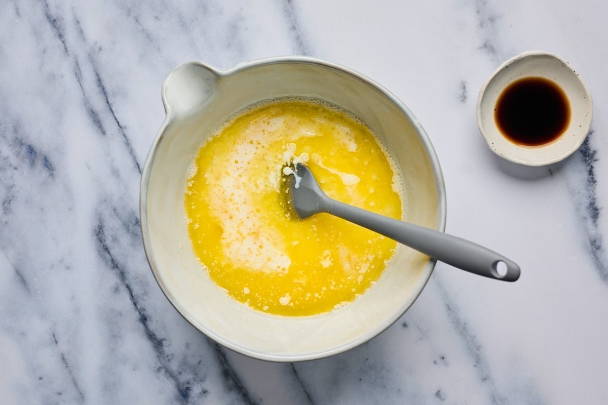melted butter and buttermilk in mixing bowl with spatula.