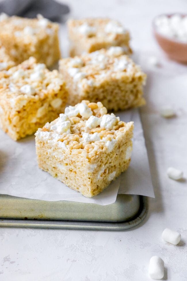 best rice krispie treats cut into squares on baking sheet.