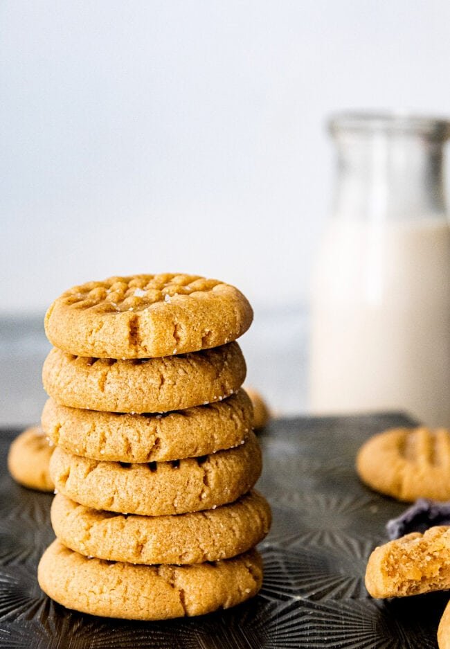 stack of 3 ingredient peanut butter cookies with milk
