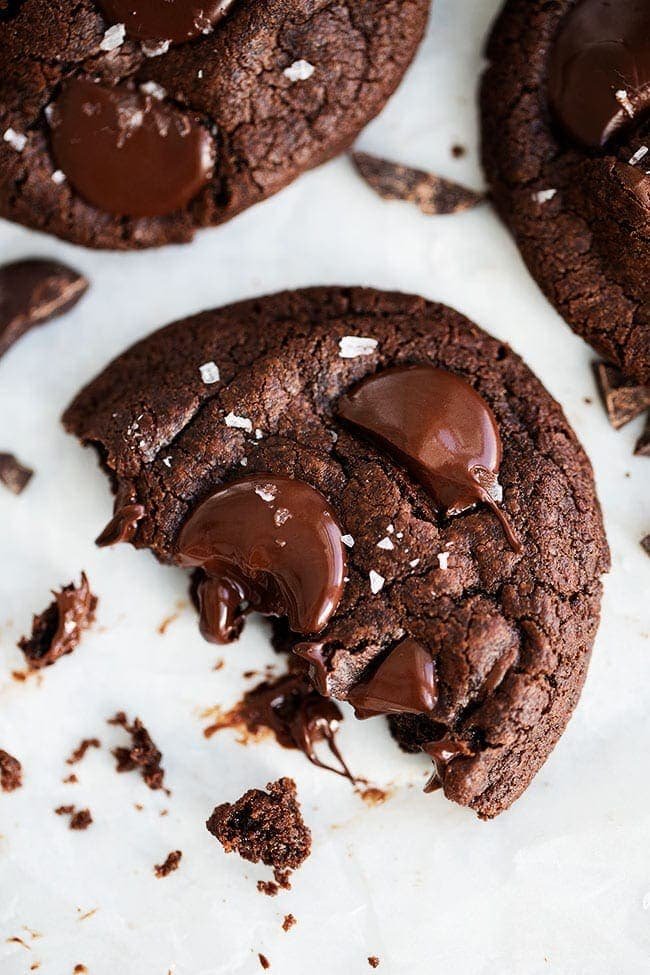Chocolate Cookies Made With Cocoa Powder, Chocolate Chips, Chocolate Chunks, And Finished With A Sprinkling Of Flaky Sea Salt. This Is The ULTIMATE Chocolate Cookie Recipe! #cookies #chocolate #chocolatecookies #dessert #baking #valentinesday #christmascookie Chocolate Cookie with a bite out of it