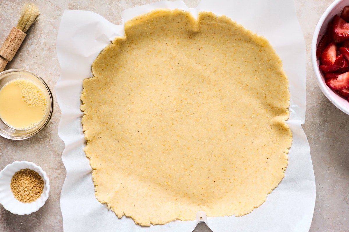 galette dough rolled out on parchment paper.