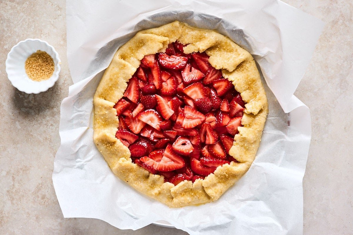 strawberry galette brushed with egg wash and sprinkled with turbinado sugar before going in oven.