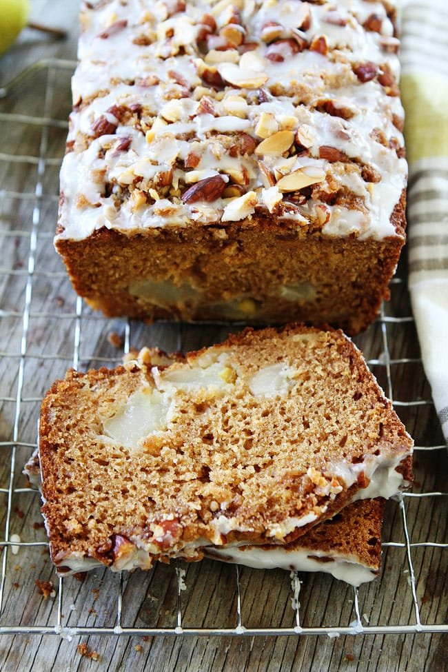 Pear Almond Streusel Bread Recipe on twopeasandtheirpod.com This easy pear quick bread has a sweet almond streusel topping and glaze. It is great for breakfast, brunch, or dessert. slices of pear bread on cooling rack