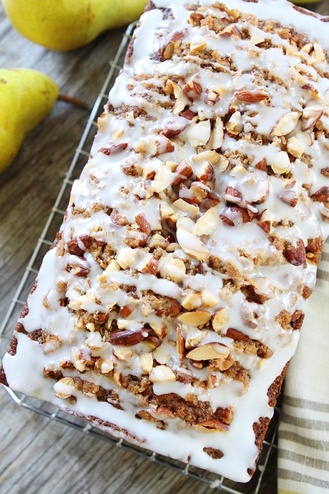 Pear Almond Streusel Bread Recipe on twopeasandtheirpod.com This easy pear quick bread is perfection! It has a sweet almond streusel topping and glaze. It is great for breakfast, brunch, or dessert. pear bread with almond streusel topping and almond glaze