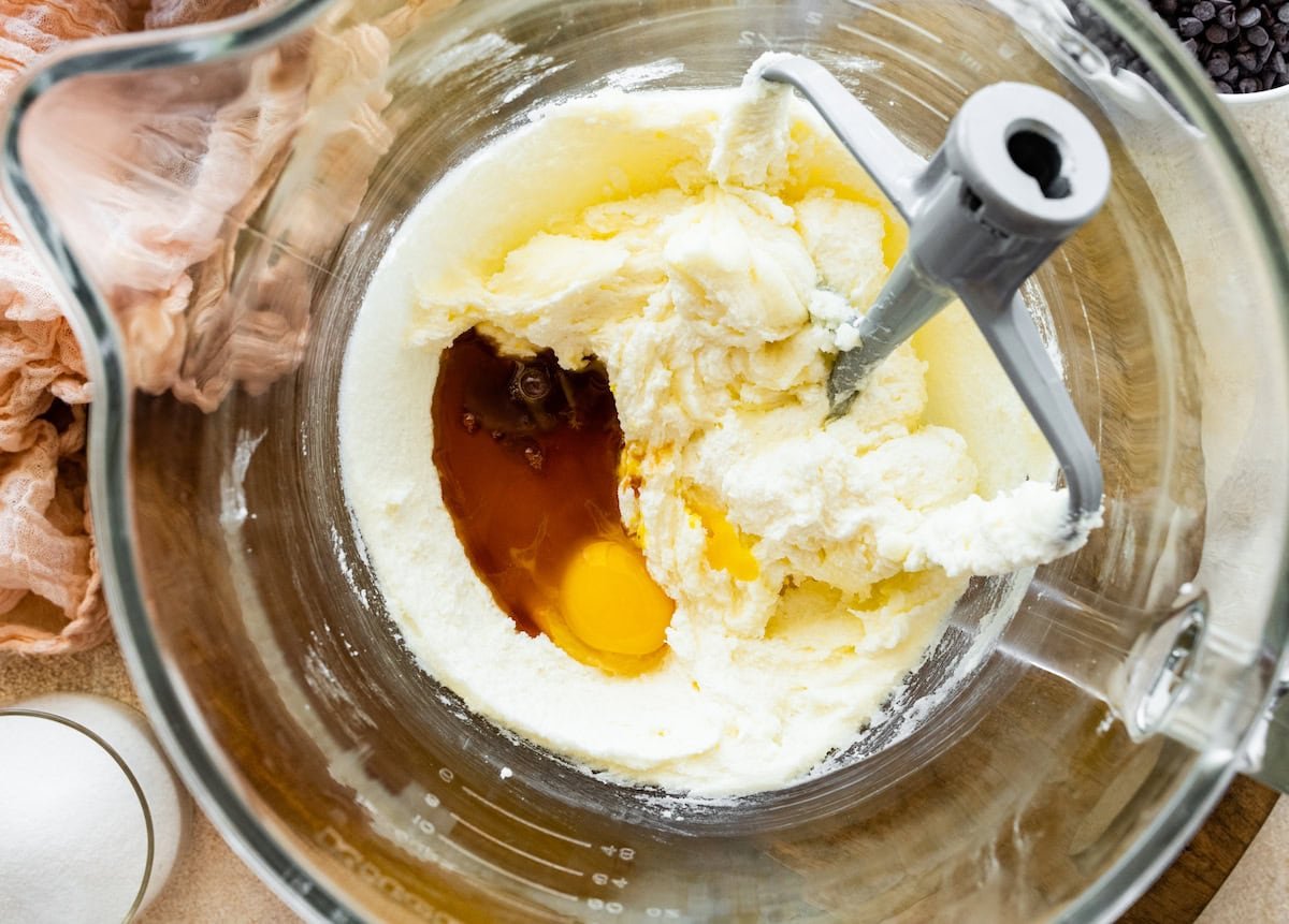 creaming butter and sugars and adding eggs and vanilla in mixing bowl.