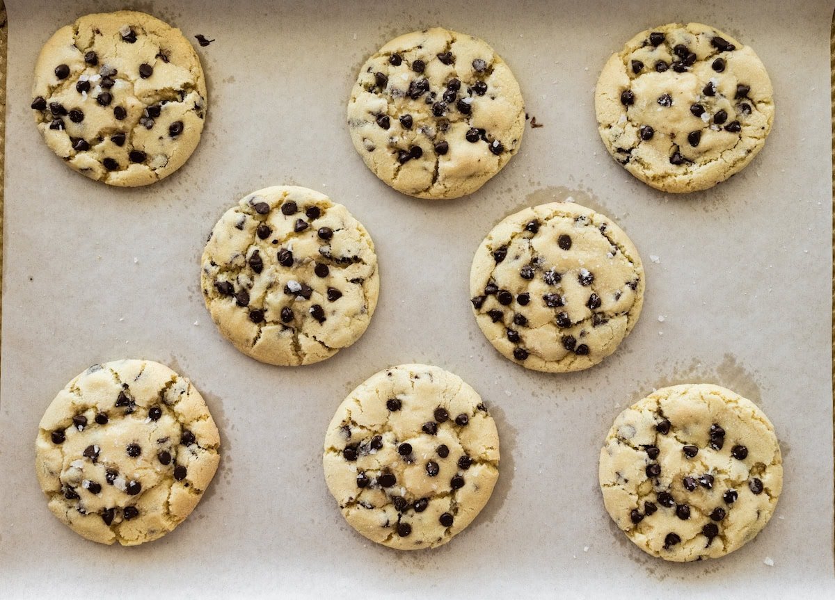 chocolate chip sugar cookies on baking sheet with parchment paper.