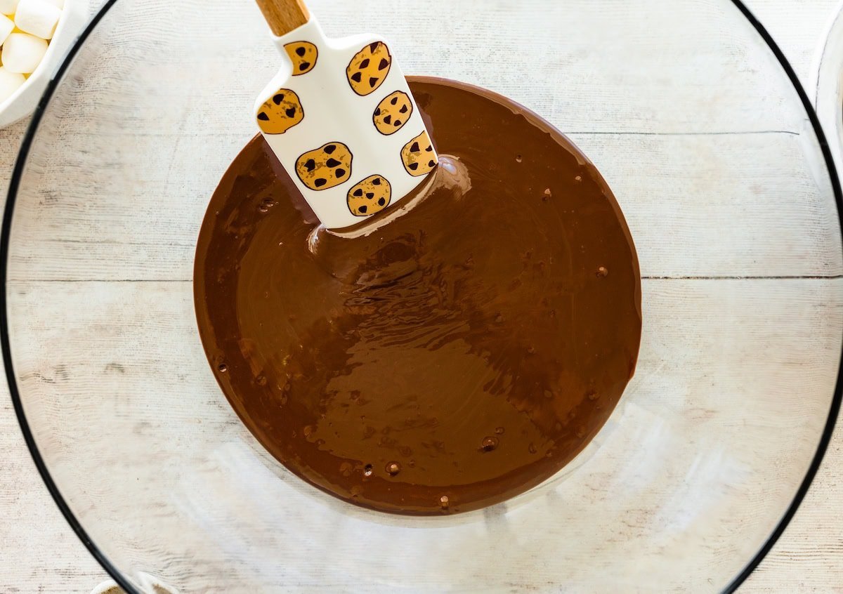 melted chocolate in mixing bowl with spatula.