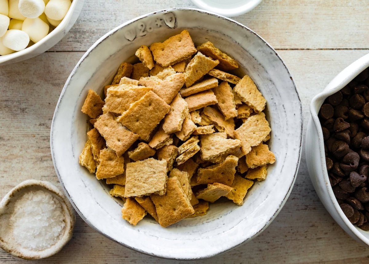 broken up graham crackers in a bowl to make s'mores clusters.