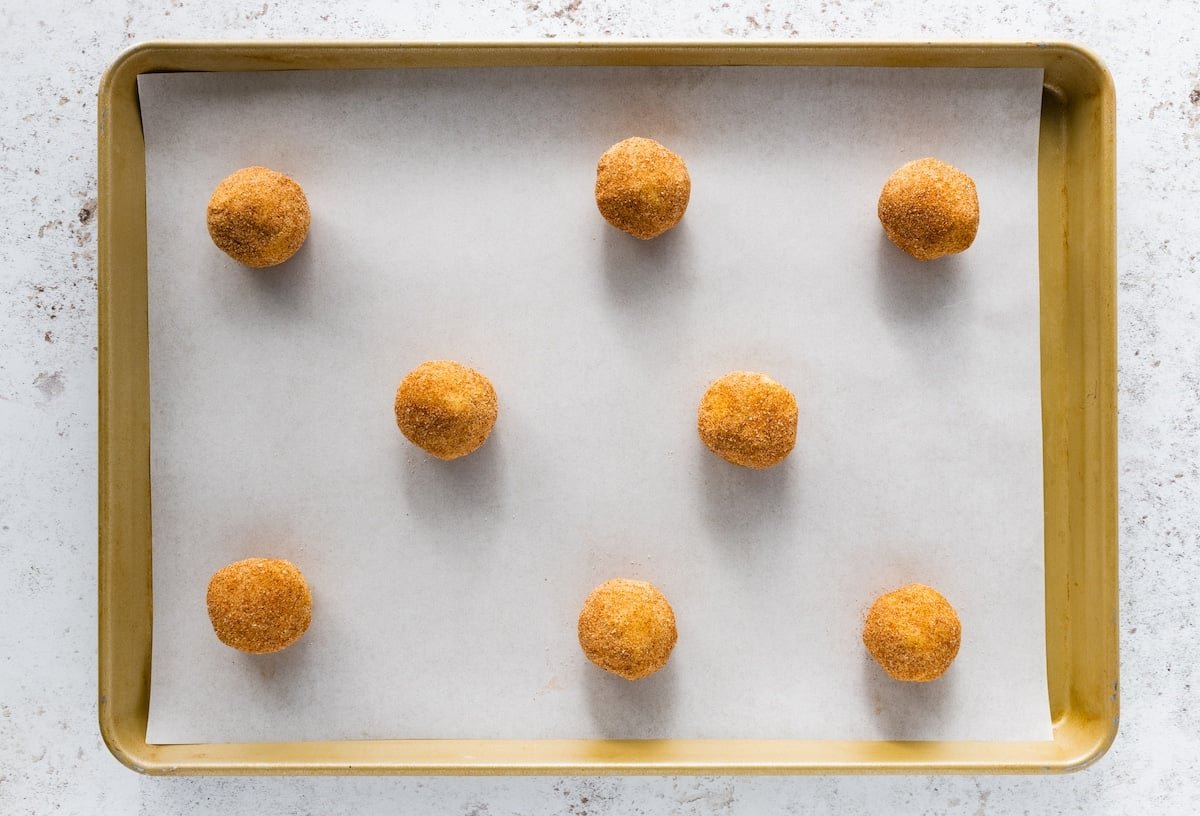 toffeedoodle dough balls on baking sheet with parchment paper.
