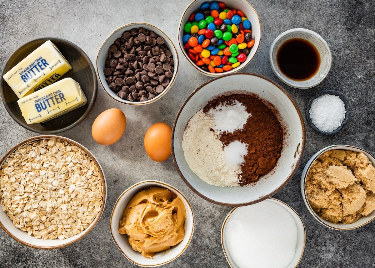ingredients in bowls to make chocolate monster cookies.