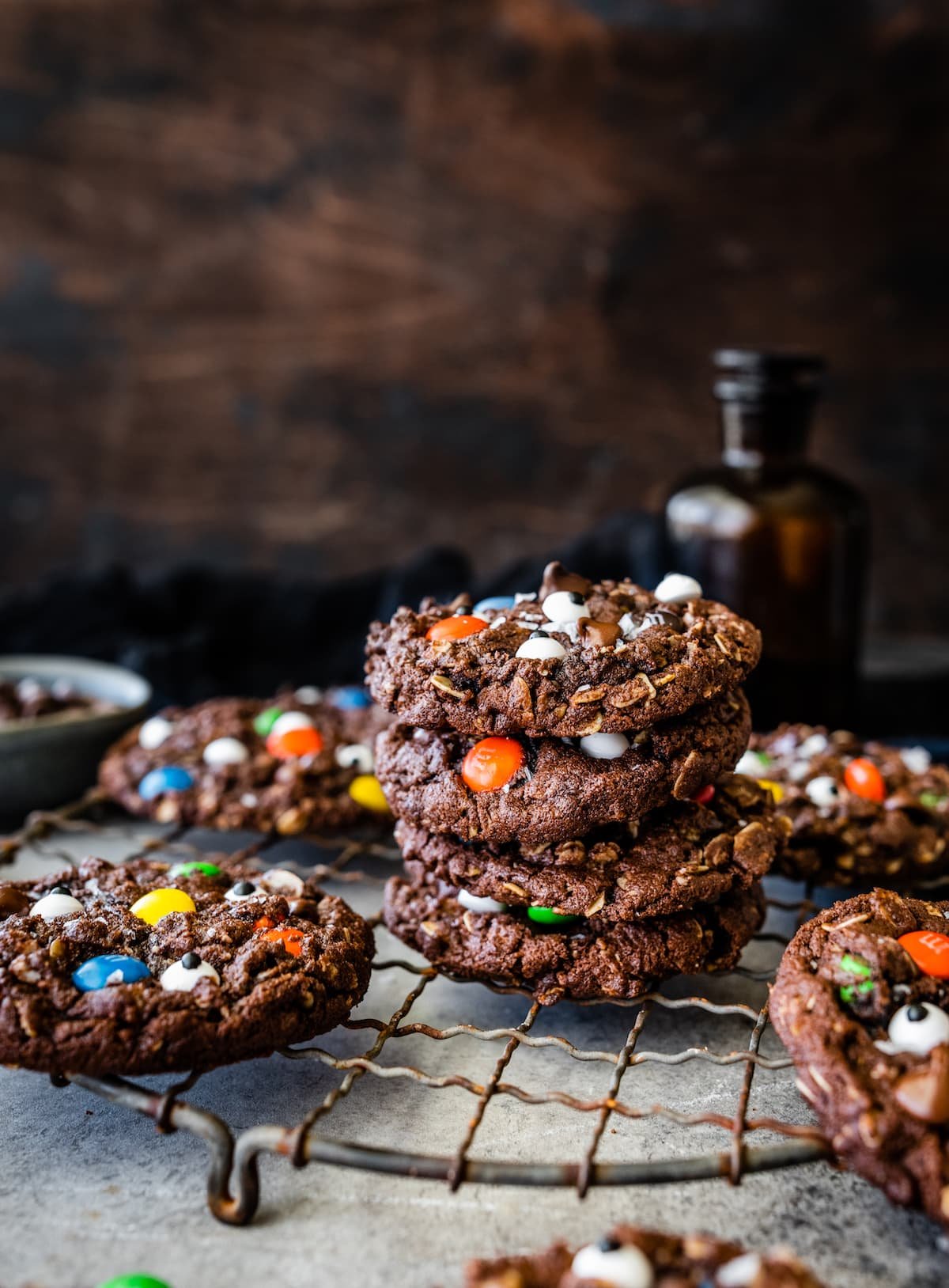 stack of chocolate monster cookies on cooling rack.