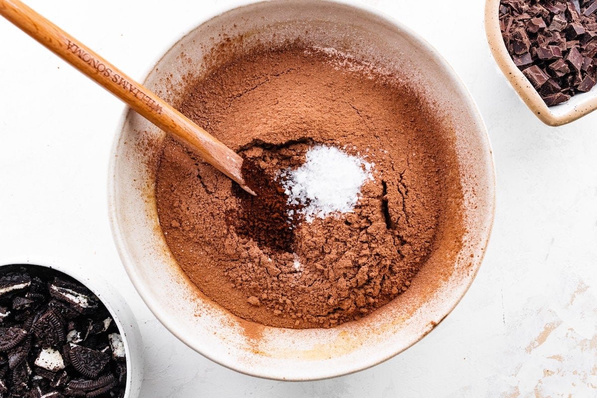 dry ingredients added to mixing bowl with spatula to make Oreo brownies.
