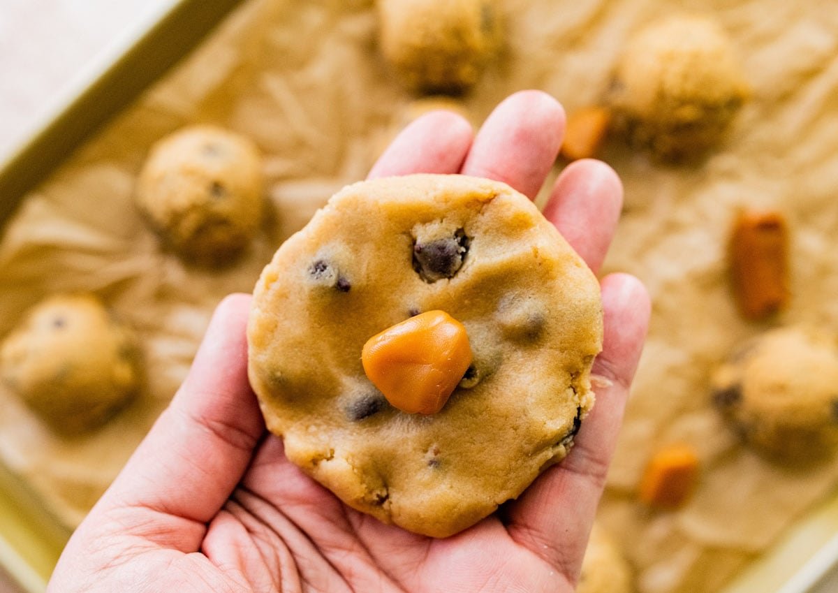 chocolate chip cookie dough flattened out with a caramel in the center.