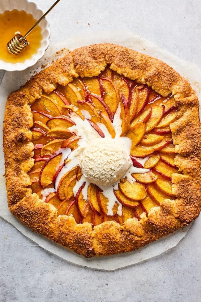 peach galette with a scoop of vanilla ice cream in the center.