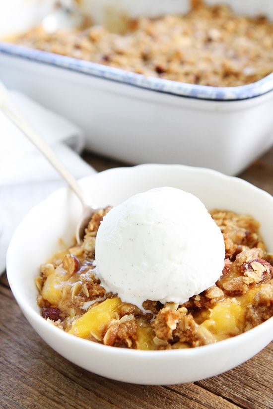 Peach Almond Crisp Recipe on twopeasandtheirpod.com Simple crisp made with fresh peaches and an almond oat topping. This easy crisp recipe is a summertime favorite! Easy Peach Crisp Recipe