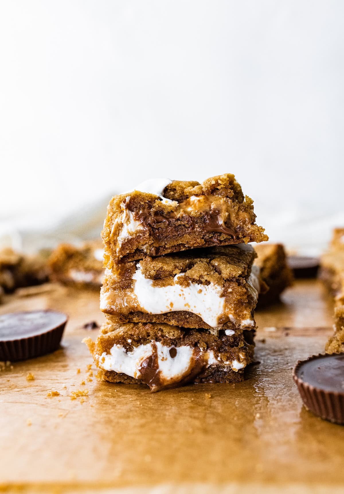 stack of gooey peanut butter s'mores bars with peanut butter cups and marshmallow creme.