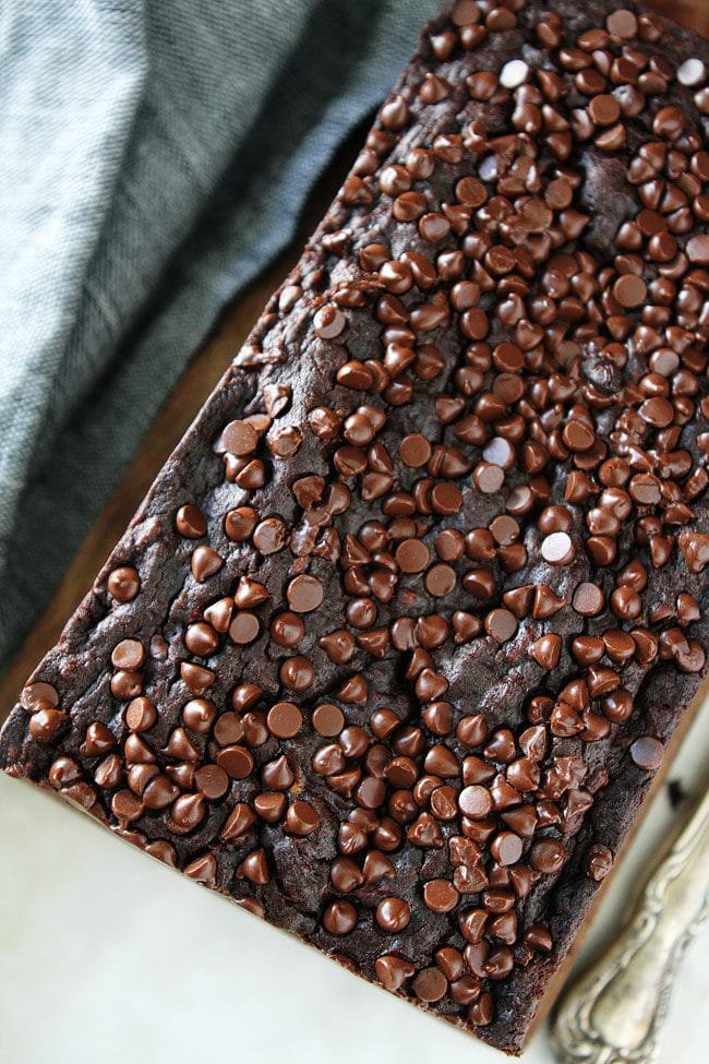 Gluten-Free Vegan Chocolate Banana Bread Recipe on twopeasandtheirpod.com You will never know this chocolate banana bread is gluten-free and vegan. It is SO rich, moist, and delicious! Chocolate Vegan Banana Bread with Vegan Mini Chocolate Chips on Top