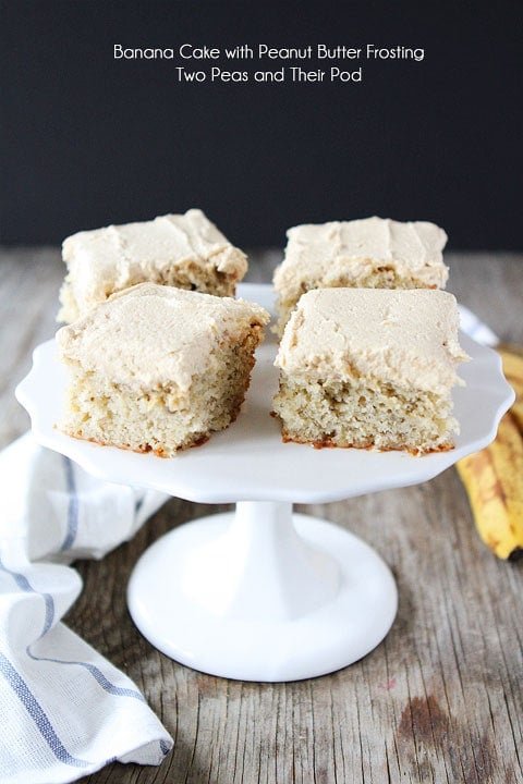 Easy Banana Cake with Peanut Butter Frosting Recipe on twopeasandtheirpod.com Everyone NEEDS this recipe! Easy banana cake served on platter