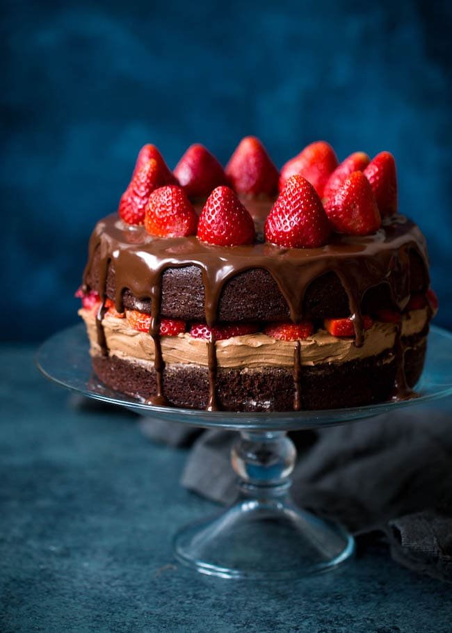 Strawberry Chocolate Cake Recipe on twopeasandtheirpod.com This chocolate cake recipe is the BEST! The cake is moist and the chocolate frosting and ganache are divine! Strawberry Chocolate Cake Recipe