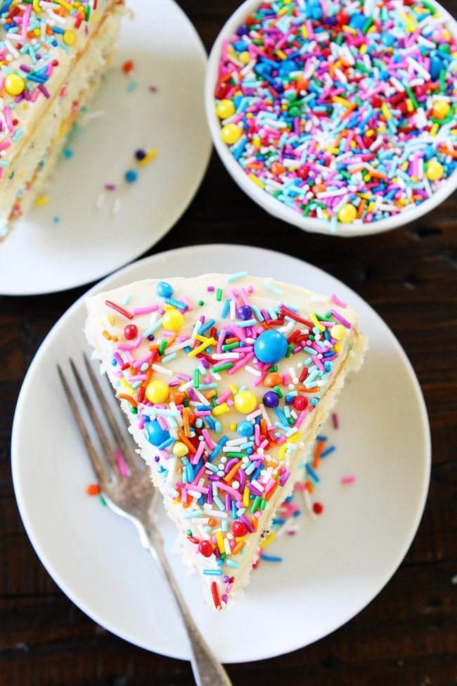 Funfetti Cake Recipe on twopeasandtheirpod.com White layer cake with sprinkles and a sweet vanilla buttercream frosting. This is the perfect cake for any celebration! Funfetti Cake with Sprinkles