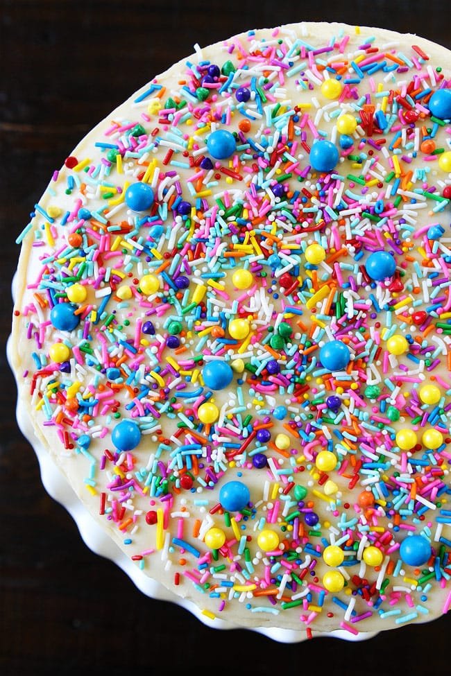 Funfetti Cake Recipe on twopeasandtheirpod.com White layer cake with sprinkles and a sweet vanilla buttercream frosting. This sprinkle cake is SO fun! Funfetti Birthday Cake From Top