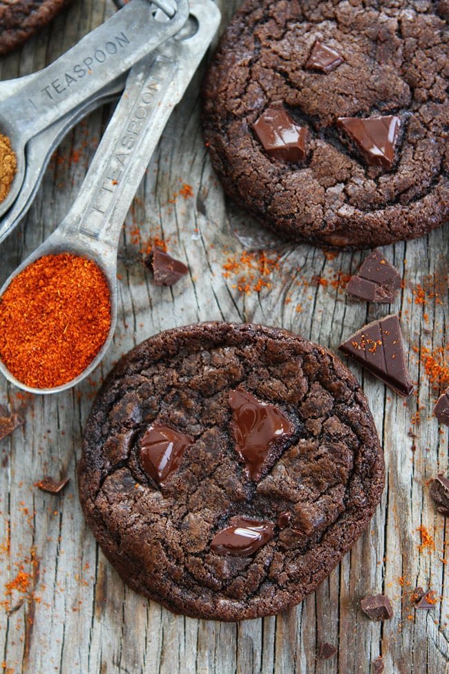 Dark Chocolate Chili Cookie Recipe on twopeasandtheirpod.com Rich chocolate cookies with a hint of cinnamon, cayenne pepper, and chili chocolate. You will love the spicy kick in these cookies! Dark Chocolate Chili Cookie Recipe