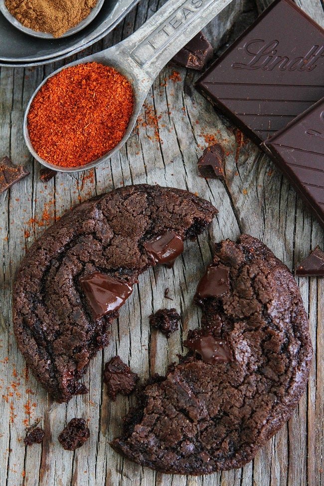 Dark Chocolate Chili Cookie Recipe on twopeasandtheirpod.com Rich chocolate cookies with a hint of cinnamon, cayenne pepper, and chili chocolate. Make sure you have a glass of milk nearby because these cookies have a spicy kick! Dark Chocolate Chili Cookie Recipe