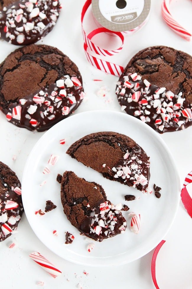 Chocolate Peppermint Ganache Cookies Recipe on twopeasandtheirpod.com Chocolate cookies dipped in ganache and sprinkled with candy cane pieces. The PERFECT Christmas cookie! Chocolate Peppermint Ganache Cookies Recipe