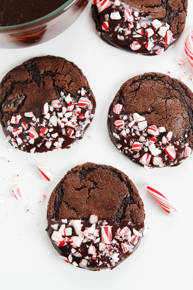 Chocolate Peppermint Ganache Cookies Recipe on twopeasandtheirpod.com Chocolate cookies dipped in ganache and sprinkled with candy cane pieces. The PERFECT cookie for the holidays! Chocolate Peppermint Ganache Cookies Recipe
