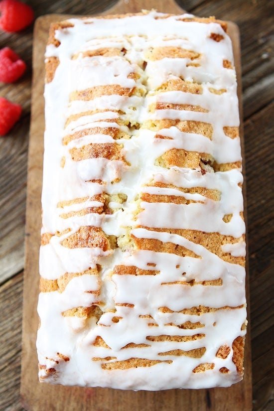 Coconut Raspberry Bread Recipe on twopeasandtheirpod.com This easy coconut bread is dotted with raspberries and drizzled with a sweet glaze! Make a loaf today! Coconut Raspberry Bread Recipe