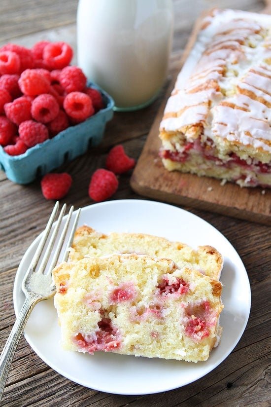 Coconut Raspberry Bread Recipe on twopeasandtheirpod.com This easy coconut bread is dotted with raspberries and drizzled with a sweet glaze! Serve for breakfast, brunch, or dessert! Coconut Raspberry Bread Recipe