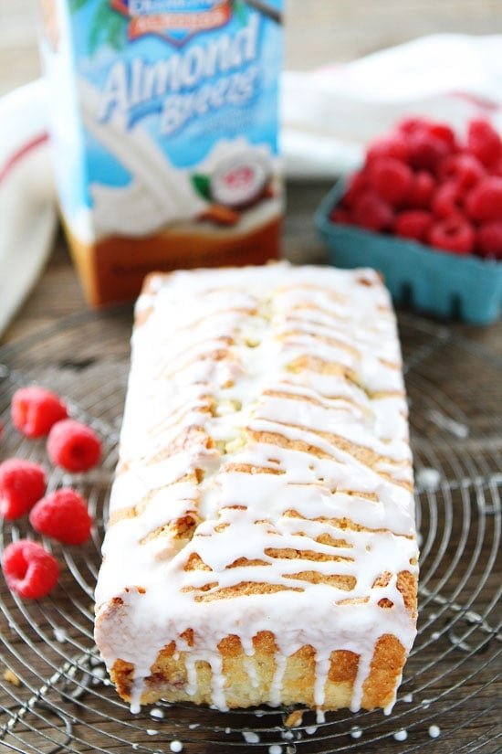 Coconut Raspberry Bread Recipe on twopeasandtheirpod.com This easy coconut bread is dotted with raspberries and drizzled with a sweet glaze! Coconut Raspberry Bread Recipe