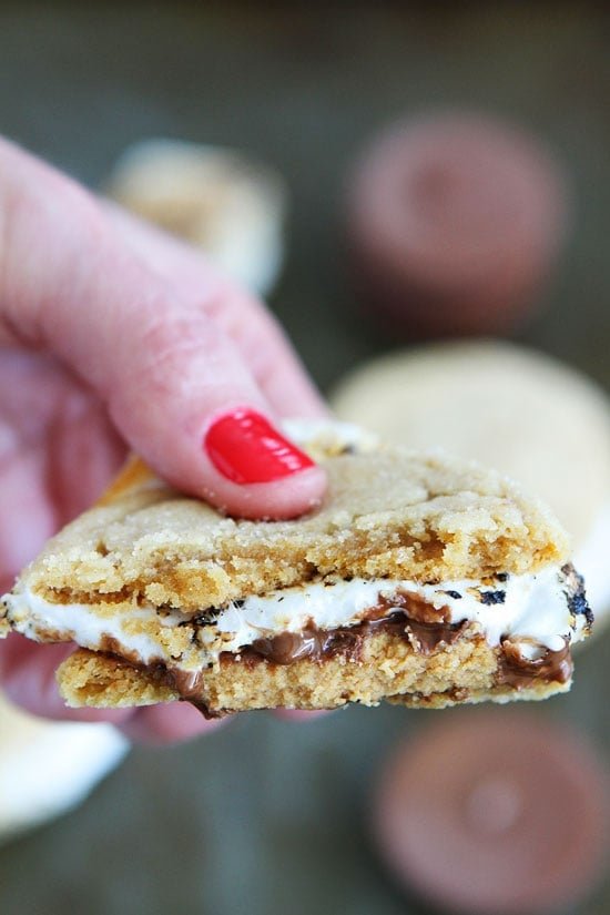 Peanut Butter Cookie S'mores Recipe on twopeasandtheirpod.com Peanut butter cookies, peanut butter cups, and marshmallows make the BEST s'mores! Peanut Butter Cookie S'mores Recipe