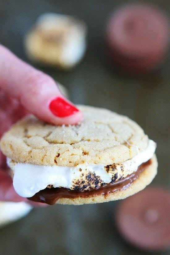 Peanut Butter Cookie S'mores Recipe on twopeasandtheirpod.com Peanut butter cookies, peanut butter cups, and marshmallows make the ULTIMATE s'mores! The perfect treat for summertime! Peanut Butter Cookie S'mores Recipe