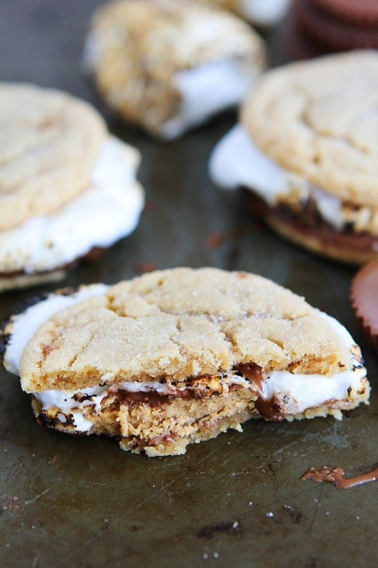 Peanut Butter Cookie S'mores Recipe on twopeasandtheirpod.com Peanut butter cookies, peanut butter cups, and marshmallows make the BEST s'mores! Make them all summer long! Peanut Butter Cookie S'mores