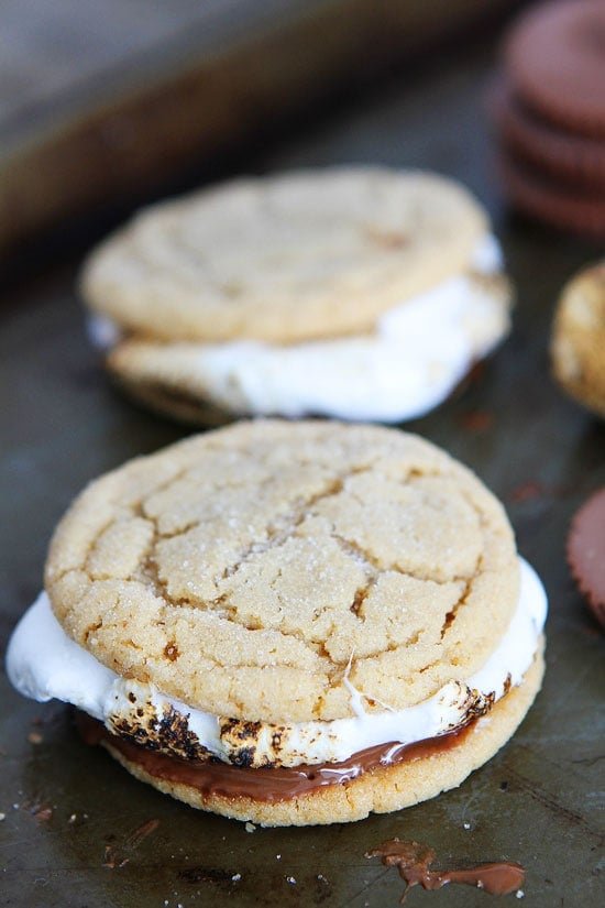 Peanut Butter Cookie S'mores Recipe on twopeasandtheirpod.com Peanut butter cookies, peanut butter cups, and marshmallows make the BEST s'mores! Peanut Butter Cookie S'mores Recipe