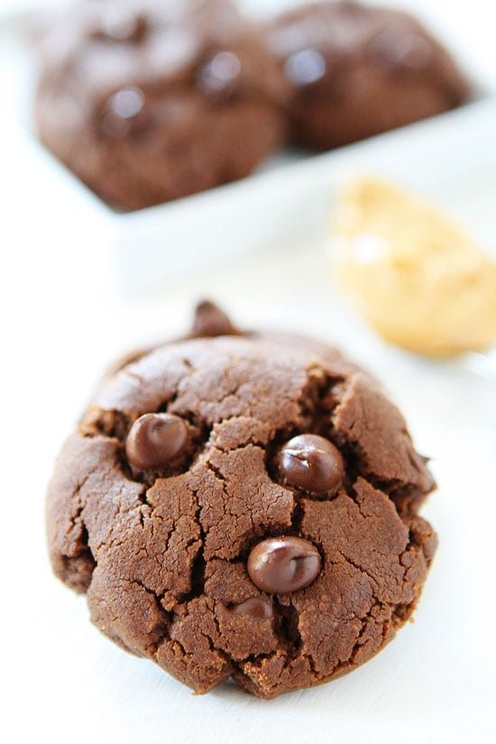 Flourless Chocolate Peanut Butter Cookies Recipe on twopeasandtheirpod.com. The chocolate and peanut butter combo is divine! We love these gluten-free cookies! Gluten free Chocolate Peanut Butter Cookie with chocolate chips on top