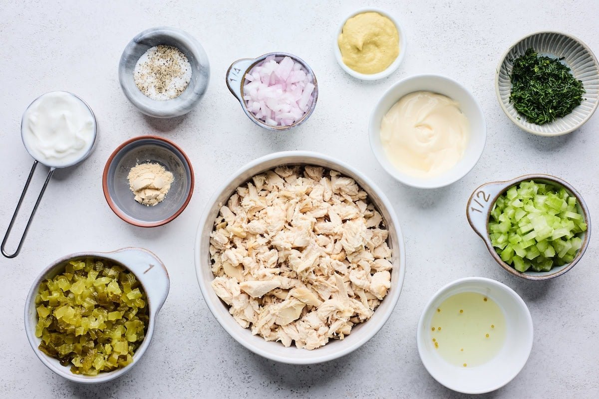 dill pickle chicken salad ingredients in bowls.