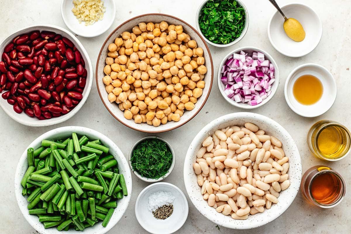ingredients in bowls to make bean salad.