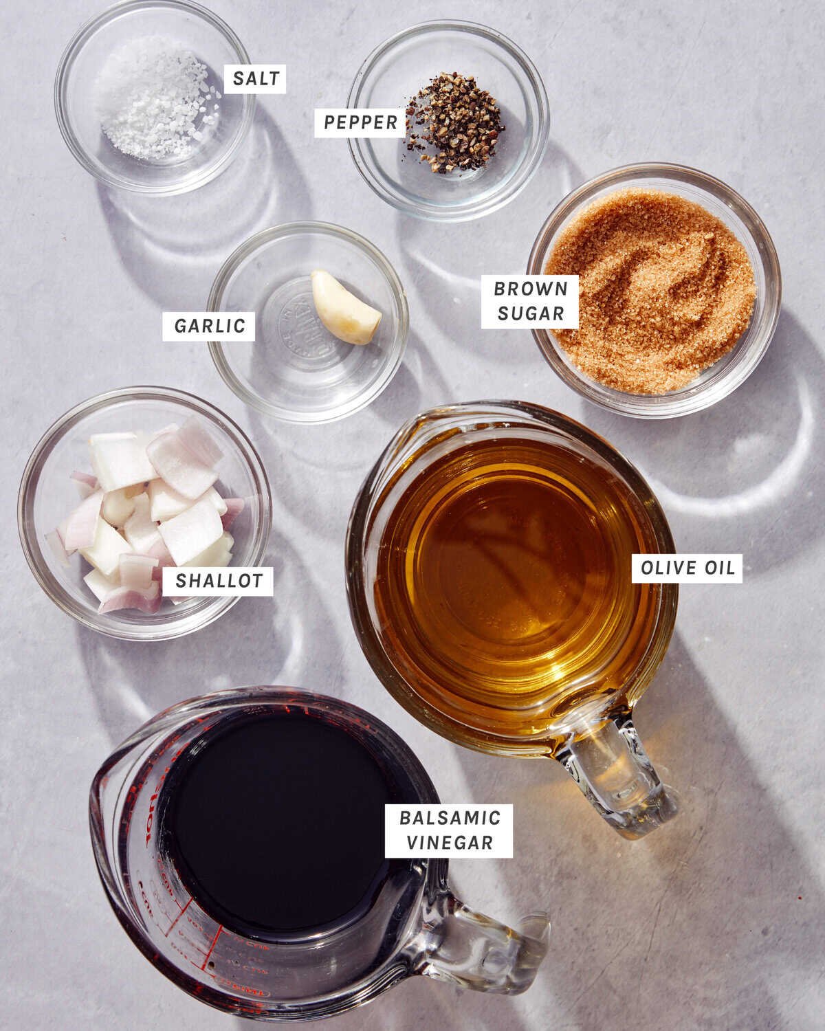 Ingredients to make balsamic vinaigrette on a kitchen counter.