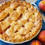 Easy Peach Pie recipe with lattice crust on a blue table cloth