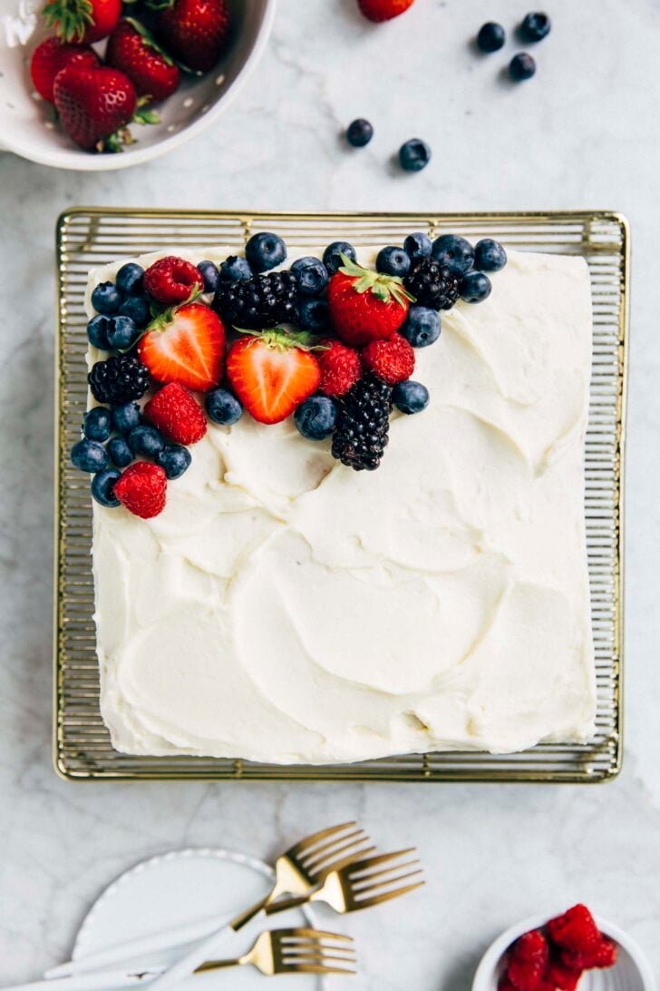 photo of the berry chantilly cake from an overhead perspective on a gold wire rack