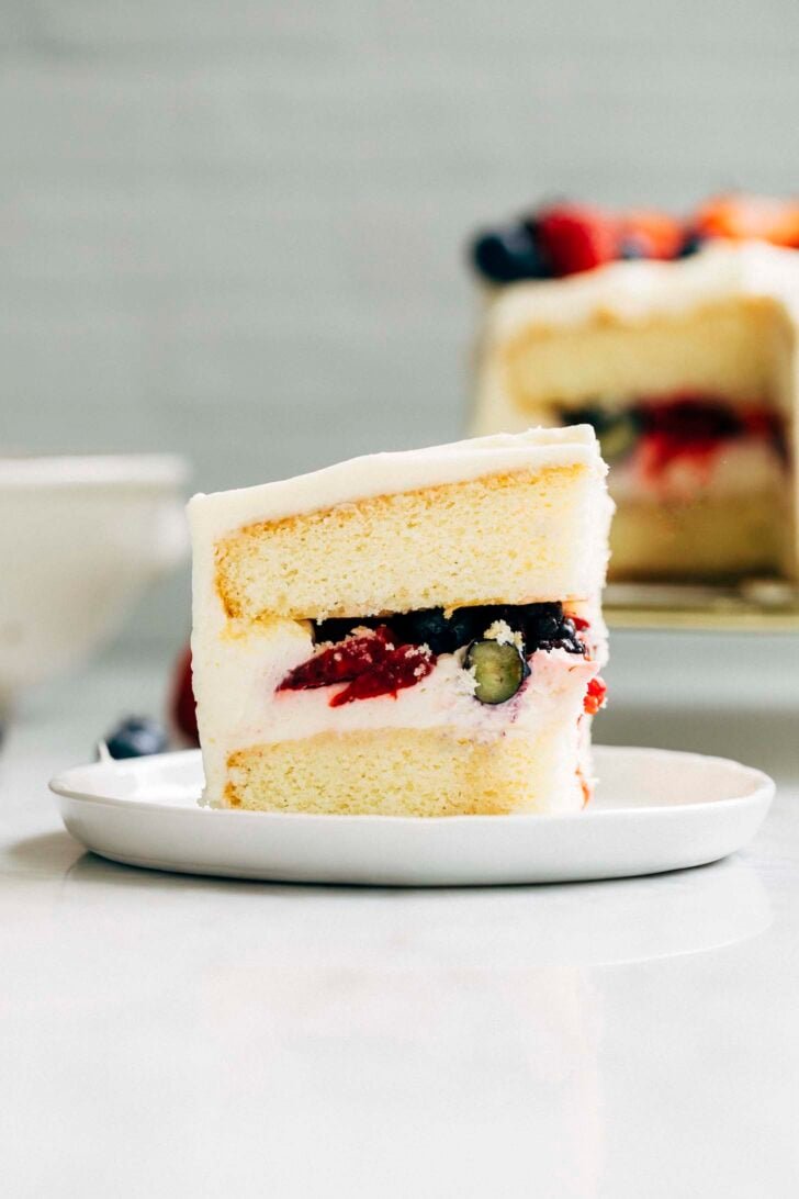 photo of a single slice of berry chantilly cake on a small white plate